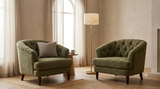 Two olive-green chenille tufted club chairs shown together as a pair